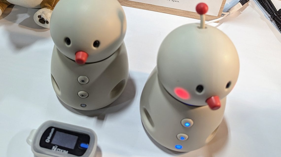 Due esemplari del robot Bocco Emo e il sensore, da posizionare (ovviamente) sul pollice